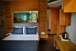 A bed or beds in a room at MyElla Boutique Hotel