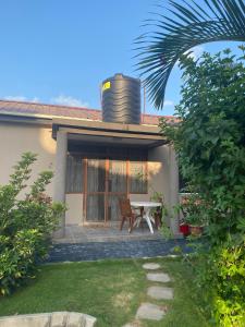 a house with a table and a water tank on the roof at Serenity Garden House in Nkunjila