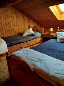 a bedroom with two beds in a cabin at La Baita di Savara - nature and silence in Valsavarenche