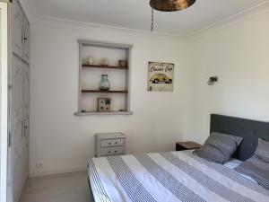 a bedroom with a bed and a white wall at Maison au calme absolue in Saint-Cézaire-sur-Siagne +76 photos