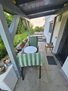 a patio with a table and two chairs on a porch at Ammonit in Münsingen