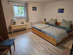 a bedroom with a bed and a window at Ammonit in Münsingen