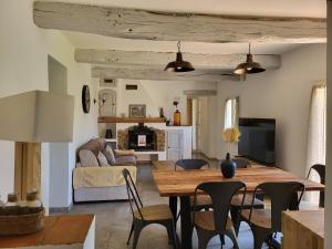 a dining room and living room with a table and chairs at Maison au calme absolue in Saint-Cézaire-sur-Siagne