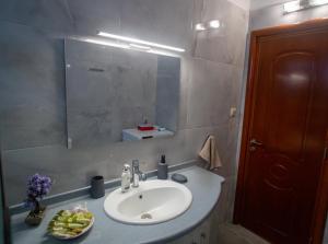 a bathroom with a sink and a mirror at LiRa in Kremasti +11 photos