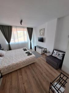 a large bedroom with a bed and a couch at Manolovi Guest House in Obzor +36 photos