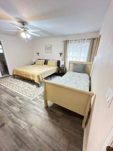 a bedroom with two beds and a ceiling fan at Tranquility Home near Beaches in Palm Coast +28 photos