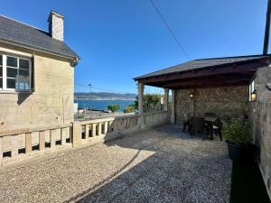 a patio of a house with a table and chairs at Chancelas A in Combarro +22 photos