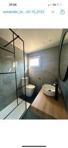 a bathroom with a toilet and a sink and a mirror at Chancelas A in Combarro