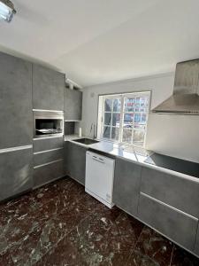 a kitchen with a sink and a stove top oven at Chancelas A in Combarro +22 photos