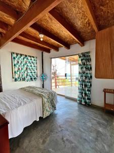 a bedroom with a bed and a large window at Condominio Vista Pacífico in Máncora Chico +83 photos