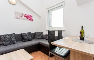 a living room with a couch and a table with wine glasses at Nives in Šilo