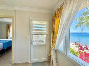 a bedroom with a window with a view of the beach at VITAMIN SEA Apartment in Özdere