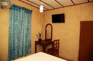 a bedroom with a bed and a mirror and a table at B City Villa Ella in Ella