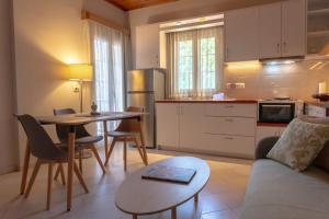 a kitchen and living room with a table and a couch at Irene Villas in Arillas