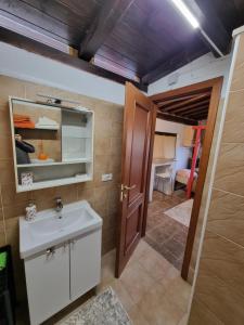 a bathroom with a sink and a mirror at Villa Shiva Cerveteri, Casa Vacanze con SPA e Idromassaggio, Relax a due passi da Roma in Cerveteri