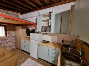 a kitchen with a white refrigerator and a sink at villa Shiva Dep in Cerveteri +34 photos