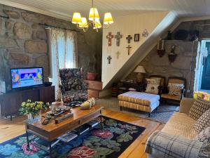 a living room with a stone wall at Casa da Costinha in Cinfães