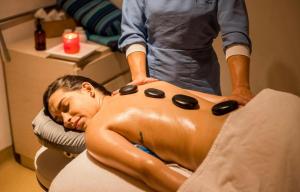 a man getting a back massage in a chair at Zuana Beach Resort in Santa Marta