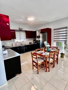 a kitchen with a table and chairs in a room at Maria 's aparment in Mursi +11 photos