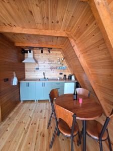 a kitchen and dining room with a wooden ceiling at Aleva in Gonio