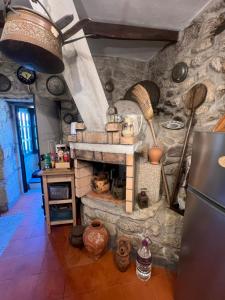 a kitchen with a stone fireplace in a room at Casa da Costinha in Cinfães