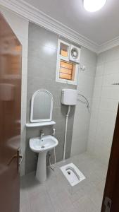 a bathroom with a sink and a toilet at Evora إيفورا in Sharurah +39 photos