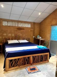 a bedroom with a wooden bed in a room at B City Villa Ella in Ella