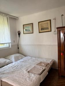 a bedroom with a bed and two pictures on the wall at Paloznak Retrospektív in Paloznak