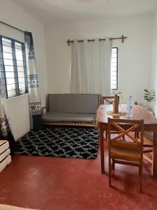 a living room with a couch and a table at Mambo Leo Hostel in Paje