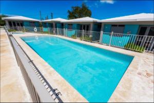 a swimming pool in front of a motel at Casa Isla Boquerón in Boqueron