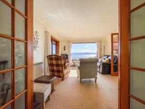 a living room with a view of the ocean at Chanonry View Holiday Cottage in Fortrose