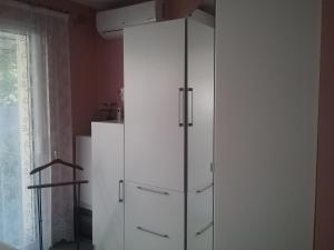 a white cabinet in a room with a window at gîte La Valentina, climatisé in Cubjac-Auvézère-Val d'Ans