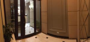 a hallway with a mirror and a room with a floor at Orynbor Boutique Hotel in Astana