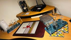 a wooden desk with a table with glasses on it at La Régence Ch 1 in Brette-les-Pins