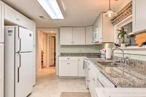 a kitchen with white cabinets and a white refrigerator at The Red Rock Retreat in Chimney Rock
