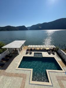 a swimming pool with a view of a lake at Harmony House - Adults Only in Dubova