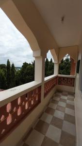 a balcony with two windows and a checkered floor at Makao in Kilifi +2 photos