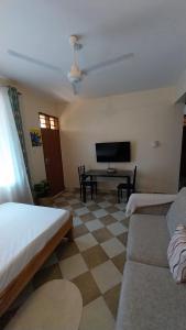 a living room with a couch and a table at Makao in Kilifi