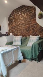 a bed in a room with a brick wall at Edwardian House in Manchester
