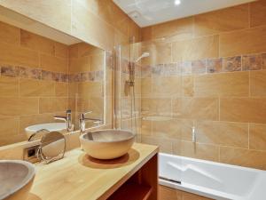 a bathroom with a bowl sink and a shower at Chalet lumineux avec jacuzzi et salle de jeux - FR-1-808-1 in Le Monêtier-les-Bains +8 photos