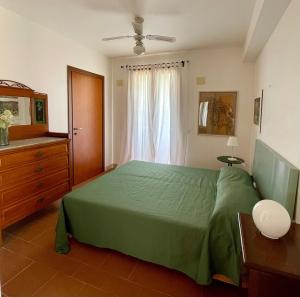 a bedroom with a green bed and a window at Villa VerdeMare Pool-Sea 300m-Nature Reserve in Plaia Grande +91 photos