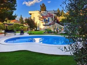a swimming pool in the yard of a house at My Place Hvar in Stari Grad