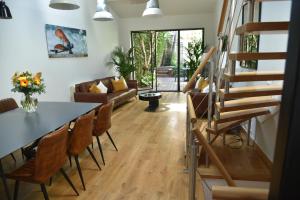 a living room with a table and chairs at Villa Le Loft by Festif Azur 4-Star 200m2 House with Garden, 5-Min Walk to Palais des Festivals and Beaches in Cannes