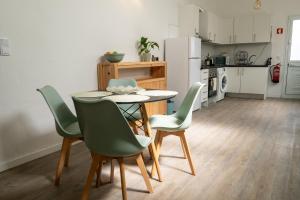 a kitchen with a table and chairs in a room at Quinta Sao Roque in São Roque