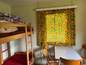 a bedroom with a bunk bed and a window with a curtain at Kemp Chatky Nové Město in Náchod