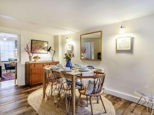 a dining room with a table and chairs at The Yellow Cottage On The Hill in Framlingham
