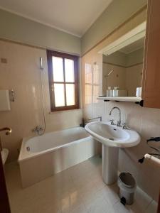 a bathroom with a tub and a sink and a bath tub at Borgo nuovo in Donigala Fenughedu