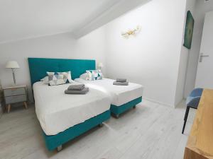 a bedroom with two beds with white and blue at Location vacances T3 à Cannes in Cannes