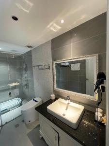 a bathroom with a sink and a toilet and a mirror at Camly Chic Villa in Da Lat