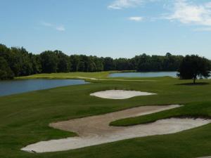 a view of a golf course with a lake at Ramada by Wyndham Savannah Gateway in Savannah